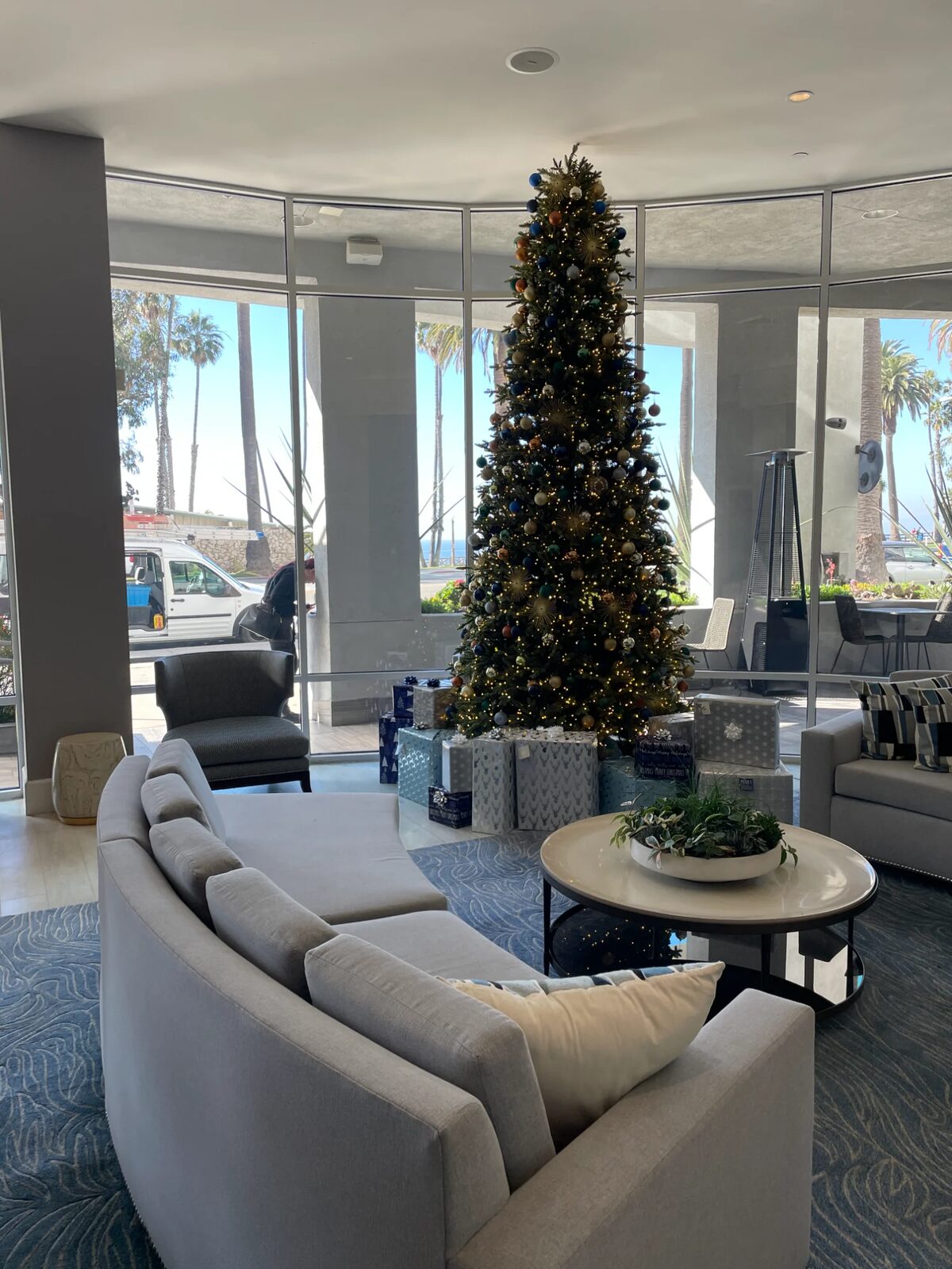 Decorated tree in a hotel lobby with ocean views